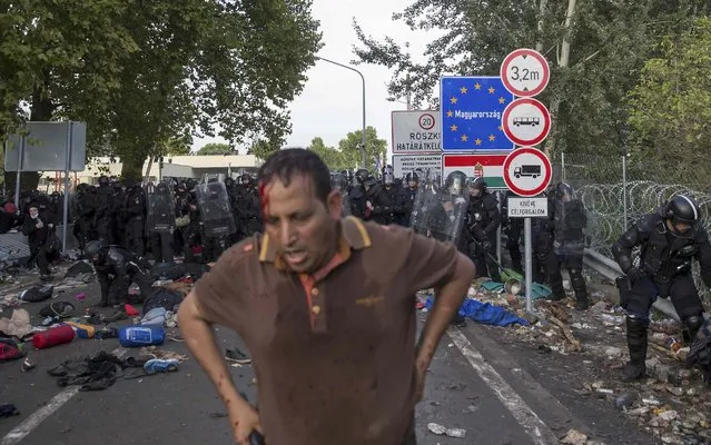 A migrant stands after clashing with Hungarian riot police at the border crossing with Serbia in Roszke, Hungary September 16, 2015. (Photo by Marko Djurica/Reuters)