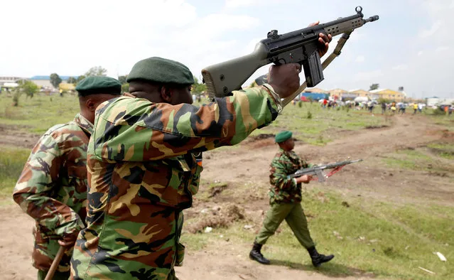 Riot police officers control supporters of Kenyan opposition leader Raila Odinga of the National Super Alliance (NASA) coalition from accessing the Jomo Kenyatta airport upon his return in Nairobi, Kenya on November 17, 2017. (Photo by Baz Ratner/Reuters)