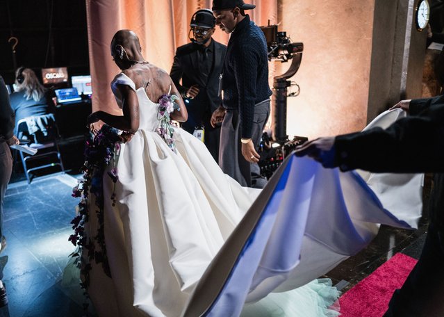 A person carries the train of Cynthia Erivo's dress backstage at the 97th Academy Awards in Hollywood, Los Angeles, California, U.S., March 2, 2025. (Photo by John Shearer/97th Oscars/The Academy/Getty Images)