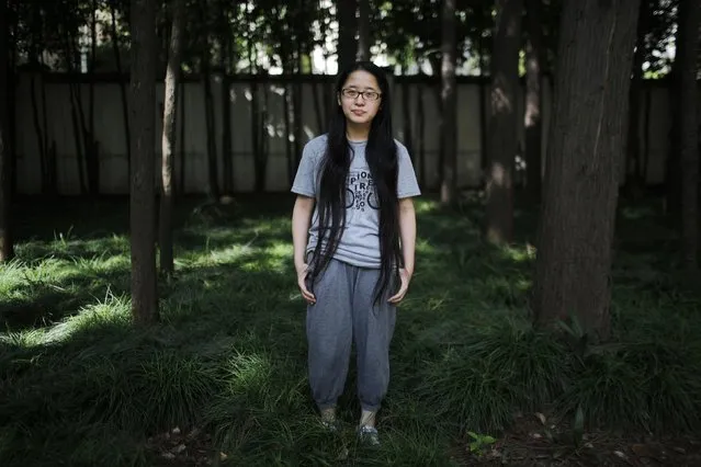 Huang Erbin, who was born in 1992, poses for a photograph in Shanghai July 31, 2014. When asked if she would like siblings Erbin said: “No, because of some financial reasons and another problem is I don't want to share my parents' love with other people”. (Photo by Carlos Barria/Reuters)