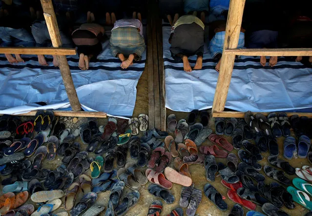 Flip-flops belonging to Rohingya refugees are pictured outside a mosque as they attend Friday prayers at Balukhali refugee camp near Cox's Bazar, Bangladesh on November 10, 2017. (Photo by Navesh Chitrakar/Reuters)