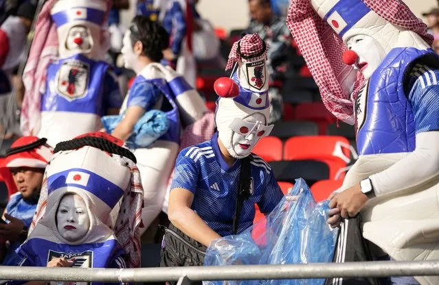 Japanese fans clean the stadium's stand after Japan was defeated by costa Rica in the World Cup, group E soccer match between Japan and Costa Rica, at the Ahmad Bin Ali Stadium in Al Rayyan , Qatar, Sunday, November 27, 2022. (Photo by Ariel Schalit/AP Photo)