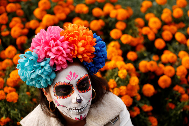 A woman dressed up as “Catrina”, a Mexican character also known as “The Elegant Death”, takes part in a Catrinas parade in Mexico City, Mexico, October 22, 2017. (Photo by Carlos Jasso/Reuters)