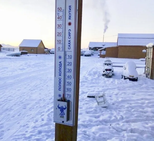 In this photo taken on Sunday, January 14, 2018, thermometer shows as the temperature dropped to –65 degrees Centigrade (–85 degrees Fahrenheit) in Tomtor village in the east of Yakutia, the center of the 2nd Borogonsky heritage of the Oymyakonsky ulus. Tomtor is known as the “Pole of Cold”, although this title is disputed by two more settlements Oimyakon and Verkhoyansk. Temperatures in the remote, diamond-rich Russian region of Yakutia have dropped to near-record lows, plunging to –67 degrees Centigrade (–88.6 degrees Fahrenheit) in some areas. (Photo by Sakhalife.ru Photo via AP Photo)