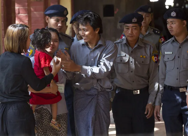 Reuters journalist Kyaw Soe Oo, centre, is welcomed by his wife and daughter upon arrival at the court for their trial Thursday, February 1, 2018, on the outskirts of Yangon, Myanmar. The trial resumes for the two Reuters journalists charged of violating state secrets. Wa Lone and Kyaw Soe Oo were arrested Dec. 12 for acquiring “important secret papers” from two police officers who had worked in Rakhine state, where abuses widely blamed on the military have driven more than 630,000 Rohingya Muslims to flee into neighboring Bangladesh.(Photo by Thein Zaw/AP Photo)