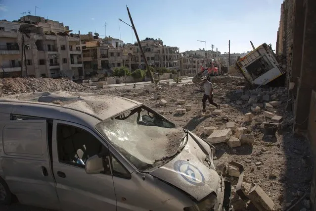 A picture shows destruction following an air strike in the rebel-held Ansari district in the northern Syrian city of Aleppo on September 23, 2016. Syrian and Russian aircraft pounded rebel-held areas of Aleppo, a monitor said, after the army announced a new offensive aimed at retaking all of the divided second city. An AFP correspondent in the opposition-held east of the city reported relentless bombardment with air strikes, barrel bombs and artillery fire hitting multiple neighbourhoods. (Photo by Karam Al-Masri/AFP Photo)