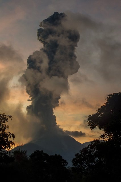 Mount Lewotobi Laki Laki, seen here from the Indonesian village of Boru, erupts on Tuesday, July 8, 2025. It sent a column of volcanic materials as high as 18 kilometers (11 miles) into the sky. (Photo by Arnold Welianto/AFP Photo)