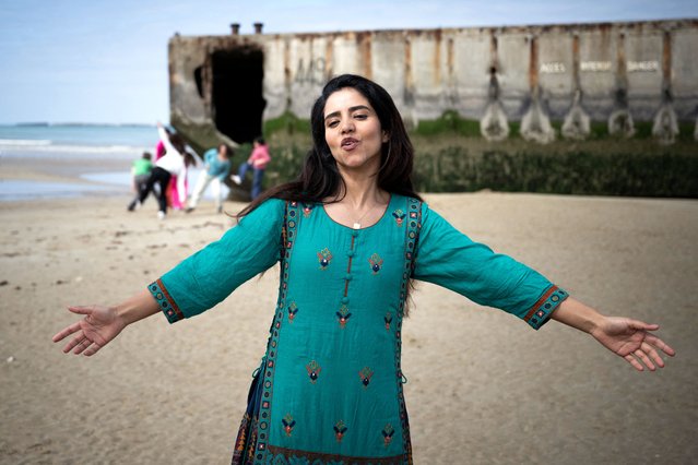 Afghan rapper and militant Sonita Alizada sings during the video shooting of her clip on the beach of Arromanches-les-Bains, north-western France, on April 24, 2024. Afghan Sunita Alizada joins a group of young people from Normandy to sing “Stand up!”, written for the 80th anniversary of the 1944 Normandy landings also known as the D-Day landings along the Normandy beaches. (Photo by Lou Benoist/AFP Photo)