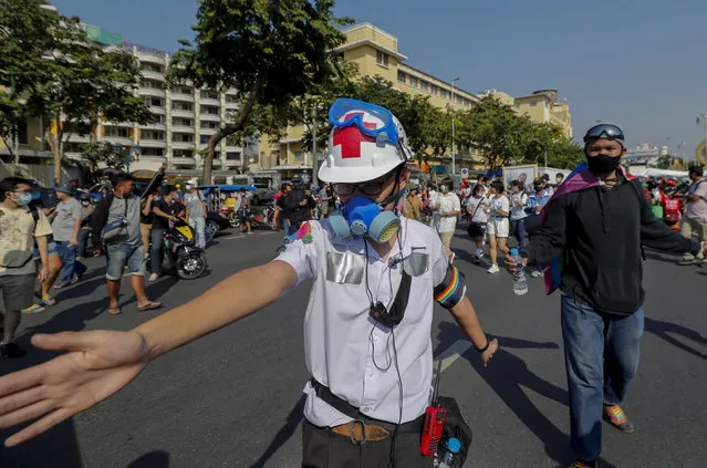 A high school student, with duct tape concealing ID tags on his school uniform,  marches in front lines during a street protest close to the Democracy Monument in Bangkok, Thailand, Saturday, November 14, 2020. (Photo by Sakchai Lalit/AP Photo)