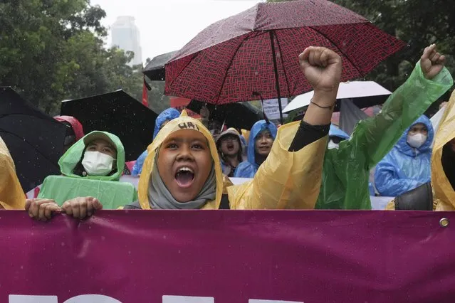 Women activists shout slogan during a rally celebrating International Women's Day in Jakarta, Indonesia, Wednesday, March 8, 2023. (Photo by Tatan Syuflana/AP Photo)