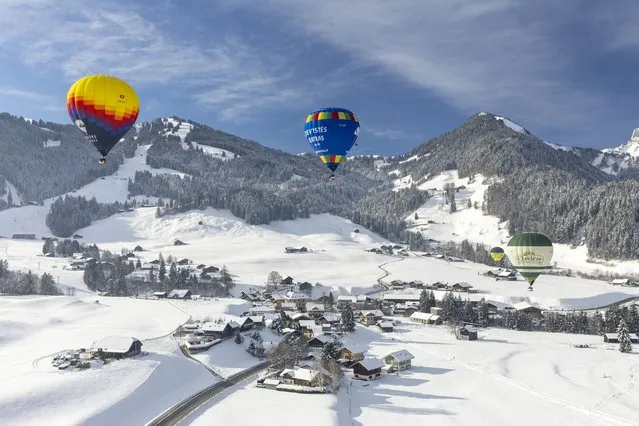 Balloons take part in the 43rd International Hot Air Balloon Festival in Chateau-d'Oex, Switzerland on January 24, 2023. (Photo by Denis Balibouse/Reuters)