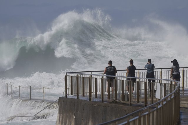People watch as large swells hit Sydney's Bronte Beach Wednesday, April 2, 2025. (Photo by Mark Baker/AP Photo)
