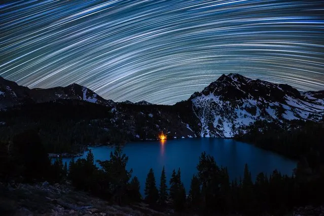 Star Trails over Green Lake. Star trails illuminate the night sky over a campfire-lit Green Lake in the Hoover Wilderness of California. (Photo by Dan Barr)