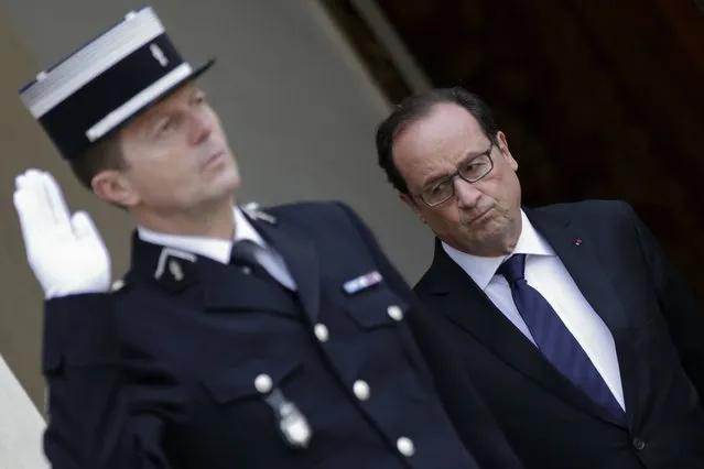 French President Francois Hollande (R) waits for guests at the Elysee Palace in Paris, France, November 17, 2015 days after the deadly attacks in the French capital. (Photo by Philippe Wojazer/Reuters)