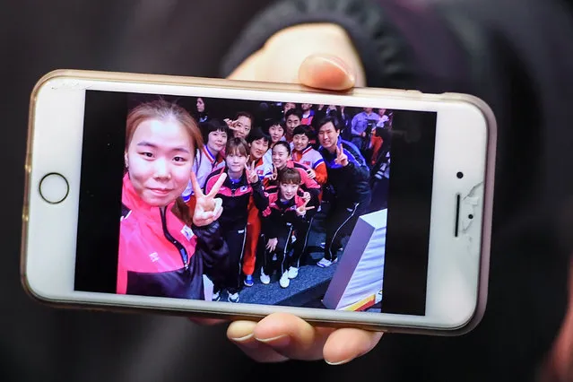 A player of South Korea shows a selfie she has taken of players of South and North Korea at the Table Tennis Team World Championships in Halmstad, Sweden, 03 May 2018. North Korea and South Korea told the organisers that they do not want to compete against each other in the women's quarter final of the Table Tennis Team World Championships here in Halmstad but form a unified Korean Team. (Photo by Christian Bruna/EPA/EFE)