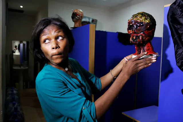Special effects artist Abioye Balogun, 23, holds a piece of her work for a Halloween film project in her art studio in Victoria Island, Lagos, Nigeria October 28, 2016. (Photo by Akintunde Akinleye/Reuters)