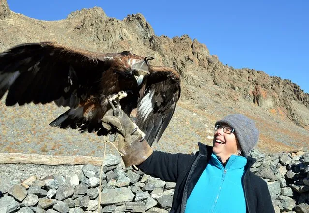 Jeanette Cox, an Adventure Sherpas client, held an eagle while visiting a hunter's home. (Photo by Brad Ruoho/The Star Tribune)