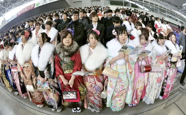 Young people in Kobe get ready to sing a song at a Coming-of-Age Day ceremony in Kobe, Hyogo Prefecture, on January 12, 2015. The song was written following the Great Hanshin Earthquake 20 years ago to encourage reconstruction in the region. (Photo by Kyodo News)
