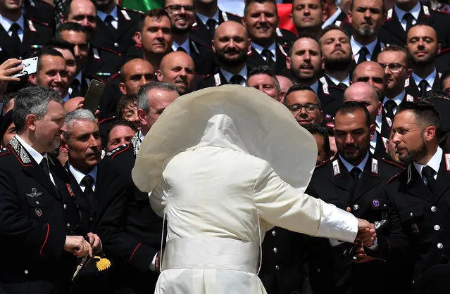 A gust of wind blows Pope Francis' mantel as he meets the Carabinieri during the general audience in Saint Peter's square at the Vatican on May 30, 2018. (Photo by Tiziana Fabi/AFP Photo)