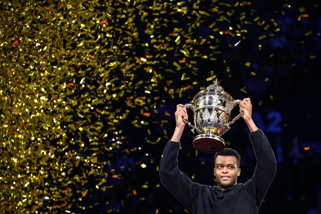 France's Giovanni Mpetshi Perricard raises the trophy after winning the final match of the Swiss Indoors ATP 500 tennis tournament against US' Ben Shelton in Basel on October 27, 2024. (Photo by Fabrice Coffrini/AFP Photo)