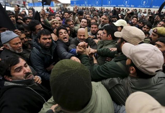 Kashmiri lawmaker Sheikh Abdul Rashid (C), commonly known as Engineer Rashid, and his supporters scuffle with police during a demonstration to mark International Human Rights Day in Srinagar December 10, 2015. (Photo by Danish Ismail/Reuters)