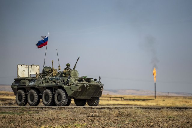 A Russian army vehicle, part of a patrol, drives past an oil field in the countryside of al-Qahtaniyah town in Syria's northeastern Hasakeh province near the Turkish border, on October 11, 2020. (Photo by Delil Souleiman/AFP Photo)