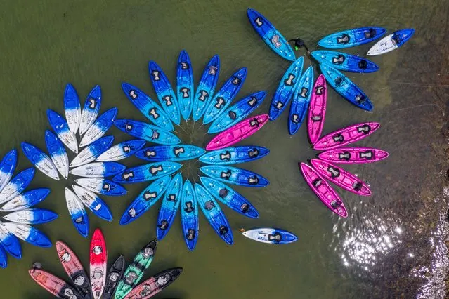 An aerial photo shows a vendor arranging kayaks in a bay in Hong Kong on June 11, 2023. (Photo by Dale de la Rey/AFP Photo)