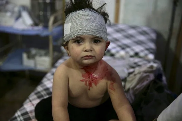 An injured child sits inside a field hospital, after what activists said was shelling by forces loyal to Syria's President Bashar al-Assad, in the Douma neighborhood of Damascus, Syria November 29, 2015. (Photo by Bassam Khabieh/Reuters)
