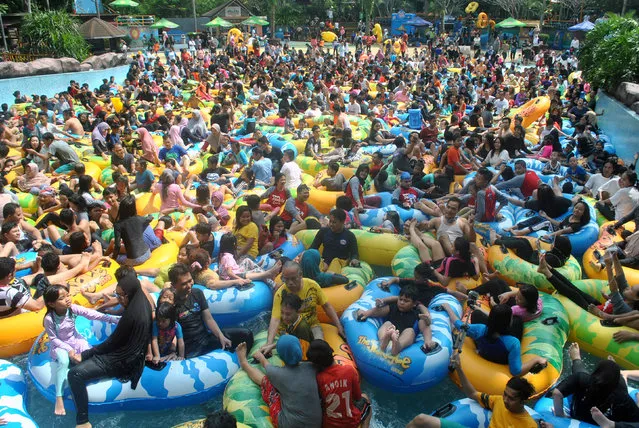 Tourists visit an attraction at a water park during the Eid al-Fitr holiday in Bogor City, West Java Indonesia on June 18, 2018 in this photo taken by Antara Foto. (Photo by Arif Firmansyah/Reuters/Antara Foto)