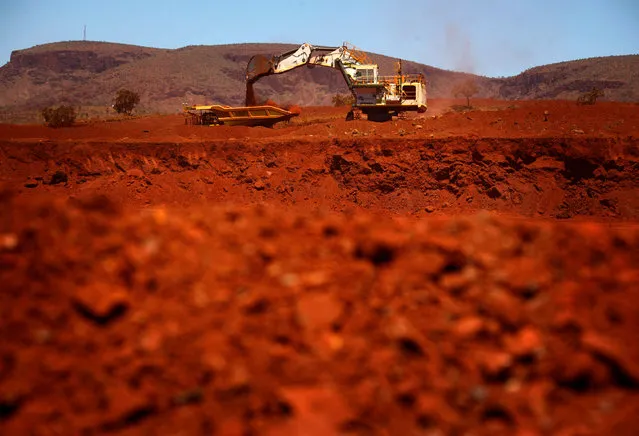 A giant excavator loads a mining truck at the Fortescue Solomon iron ore mine located in the Sheila Valley, around 400 km south of Port Hedland, in the Pilbara region of Western Australia December 2, 2013. (Photo by David Gray/Reuters)