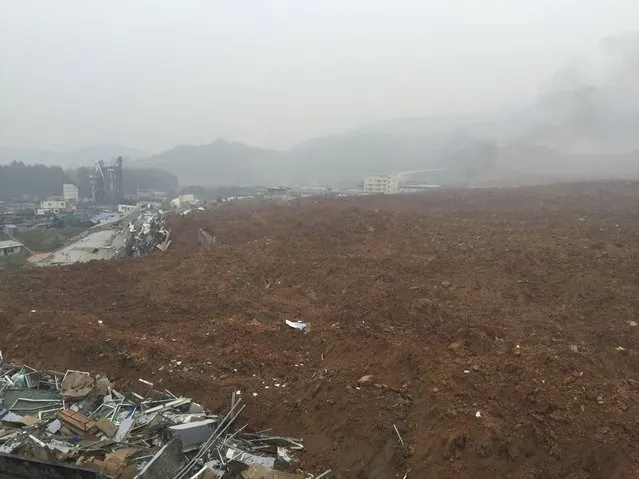 A general view shows buildings covered by mud at the site of a landslide at an industrial park in Shenzhen, Guangdong province, China, December 20, 2015. (Photo by Reuters/Stringer)