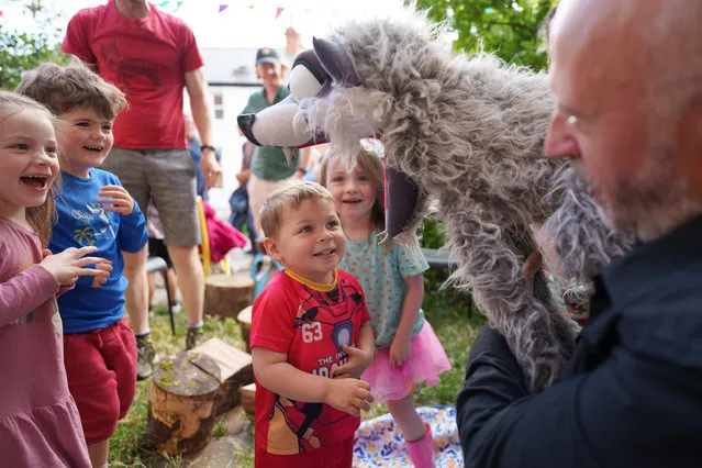 David Stirbu (2) looks the big bad wolf in the mouth during a puppet show at St Anne’s Road Pocket Park in Drumcondra, Dublin on June 25, 2023. (Photo by Fran Veale/The Irish Times)