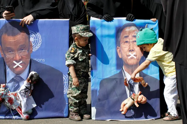 A boy holds a toy against a defaced poster of the U.N. Secretary-General Ban Ki-moon during a protest against Saudi-led air strikes in Sanaa, Yemen November 26, 2016. (Photo by Mohammed Sayaghi/Reuters)