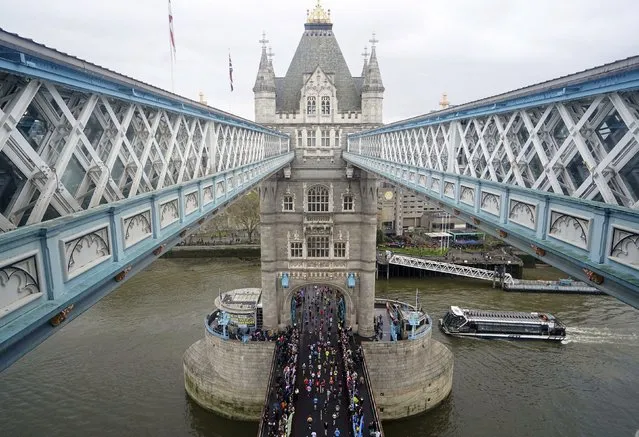 Competitors cross Tower Bridge during the London Marathon, in Sunday April 23, 2023. (Photo by Gareth Fuller/PA Wire via AP Photo)