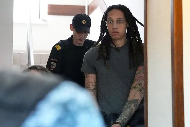 WNBA star and two-time Olympic gold medalist Brittney Griner is escorted to a courtroom for a hearing, in Khimki just outside Moscow, Russia, Monday, June 27, 2022. More than four months after she was arrested at a Moscow airport for cannabis possession, American basketball star Brittney Griner is to appear in court Monday for a preliminary hearing ahead of her trial. (Photo by Alexander Zemlianichenko/AP Photo)