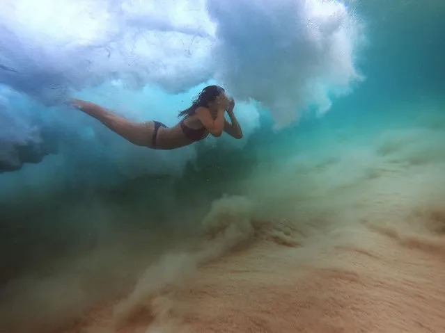 A girl dives under a wave at Bondi Beach as temperatures reached 29 degrees celsius on December 17, 2020 in Sydney, Australia. The Bureau of Meteorology predicted the arrival of thunderstorms and showers later today with a southerly change bringing possible severe storms around the Sydney region. (Photo by Mark Evans/Getty Images)