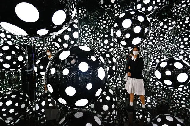 A lady visits art installation Dots Obsession – Aspiring to Heaven's Love, at Visual Culture Museum in Hong Kong on August 10, 2023. The artwork by Japanese artist Yayoi Kusama, who has lived in the United States between 1958 and 1975, features her famous polka dots and reflective mirrors inside a cubic environment which offers a kaleidoscopic visual experience. (Photo by Daniel Ceng Shou-Yi/ZUMA Press Wire/Alamy Live News)