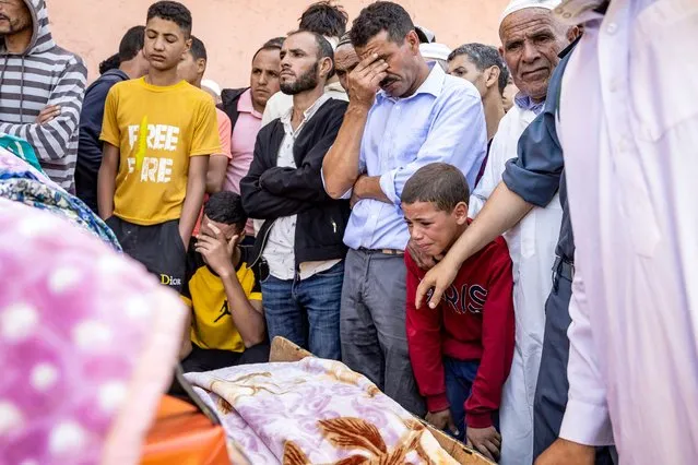 People mourn in front of the body of a victim killed in an earthquake in Moulay Brahim, Al Haouz province, on September 9, 2023. Morocco's deadliest earthquake in decades has killed at least 820 people, officials said on September 9, causing widespread damage and sending terrified residents and tourists scrambling to safety in the middle of the night. (Photo by Fadel Senna/AFP Photo)