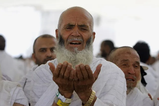 An Afghani Muslim pilgrim prays after he casts stones at a pillar, symbolizing the stoning of Satan, in a ritual called “Jamarat”, the last rite of the annual hajj, in the Mina neighborhood of Mecca, Saudi Arabia, Tuesday, October 15, 2013. The 10th day of the Islamic lunar month of Dhul-Hijja, during the hajj, is the beginning of Eid al-Adha, the most important Islamic holiday, to mark the willingness of the Prophet Ibrahim, or Abraham to Christians and Jews, to sacrifice his son. (Photo by Amr Nabil/AP Photo)
