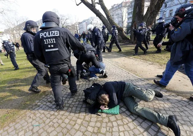 Policemen detain members of “Blockupy” anti-capitalist movement near the European Central Bank (ECB) building before the official opening of its new headquarters in Frankfurt March 18, 2015. (Photo by Michael Dalder/Reuters)