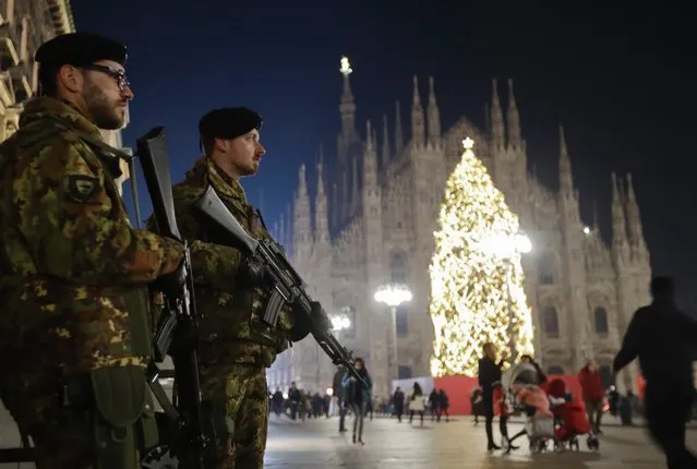 Italian soldiers patrol next to Milan's gothic cathedral, Italy, Thursday, December 22, 2016. Following the truck attack on a Christmas market in Berlin, Italy is strengthening security measures for areas where crowds are expected for Christmas ceremonies. (Photo by Luca Bruno/AP Photo)