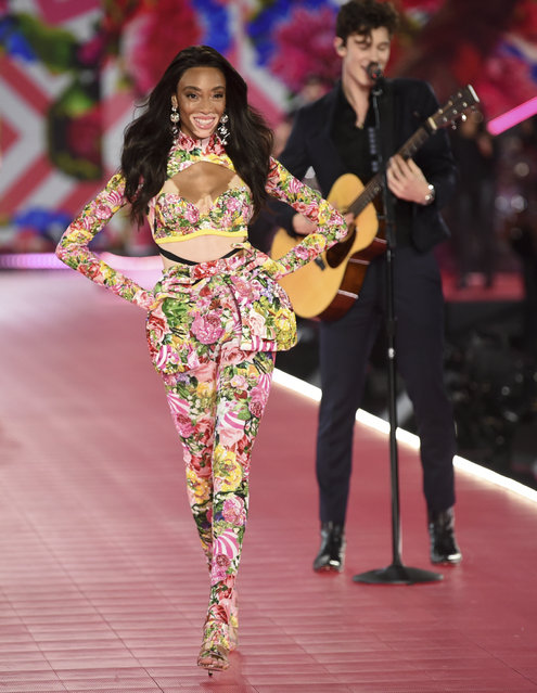 Winnie Harlow, left, walks the runway as Shawn Mendes performs during the 2018 Victoria's Secret Fashion Show at Pier 94 on Thursday, November 8, 2018, in New York. (Photo by Evan Agostini/Invision/AP Photo)