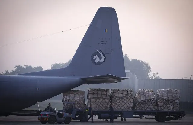 Malaysian air force personnel load relief supplies donated by Malaysian government for victims of Typhoon Haiyan in the Philippines, at the Air Force base in Subang, Malaysia, Wednesday, November 13, 2013. Foreign governments and agencies have announced a major relief effort to help victims of the Philippine typhoon. (Photo by Vincent Thian/AP Photo)