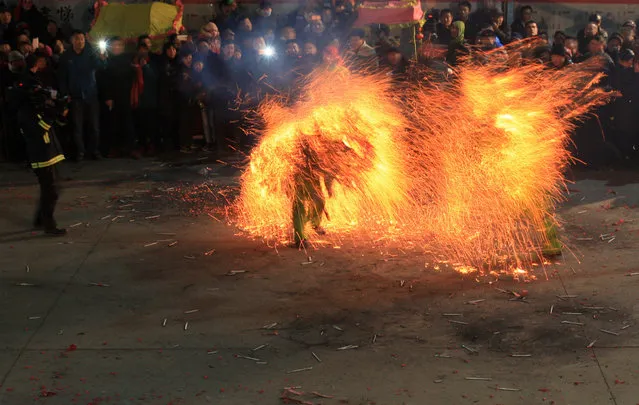Folk artists perform “Huohu”, a traditional local fire dance ahead of the upcoming Spring Festival, in Zoucheng, Shandong province, February 1, 2016. (Photo by Reuters/Stringer)