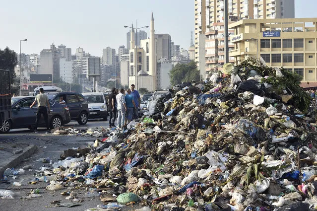 Protesters block the road with garbage during a protest after Lebanese Prime Minister-Designate Saad Hariri abandoned his effort to form a new government, in Beirut, Lebanon, 15 July 2021.Hariri, who was tasked nine months ago with forming the new government, said on 15 July he is stepping down a day after he presented the cabinet proposal to President Michel Aoun who has not accepted the government. (Photo by Wael Hamzeh/EPA/EFE)