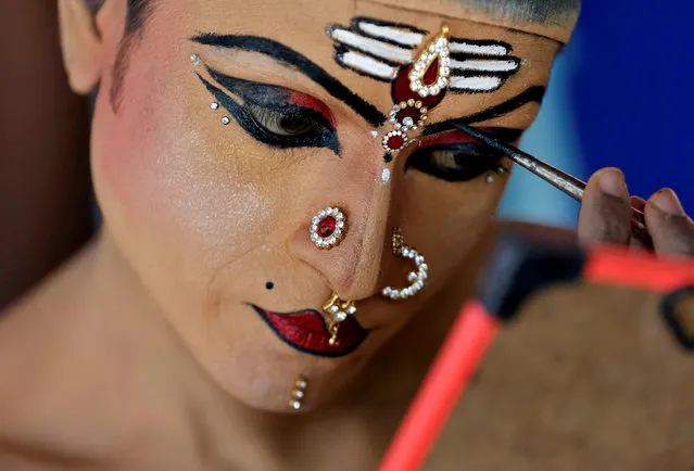 A man gets ready backstage before performing in the 35th Cochin Carnival, which is held annually to welcome the start of the New Year at Fort Kochi in the southern state of Kerala, India, January 1, 2019. (Photo by Sivaram V/Reuters)
