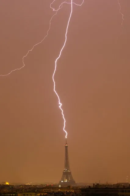 A day of storms and lightning in Paris as lightning hits the top of the Eiffel Tower twice in a matter of hours, captured both times by photographer Bertrand Kulik on June 18, 2023. (Photo by Bertrand Kulik/Animal News Agency)