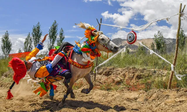 To ride skills during a horse race in Gangdan Village of Gonggar County, Southwest China's Tibet Autonomous Region on August 26, 2021. (Photo by Chine Nouvelle/SIPA Press/Rex Features/Shutterstock)