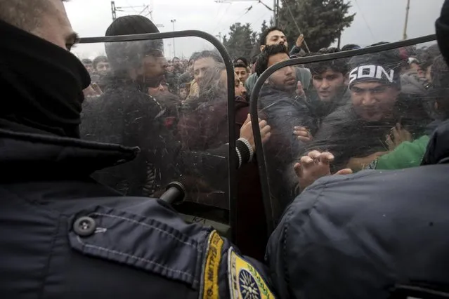 Stranded refugees and migrants try to break a Greek police cordon in order to approach the border fence at the Greek-Macedonian border, near the Greek village of Idomeni, February 29, 2016. (Photo by Alexandros Avramidis/Reuters)