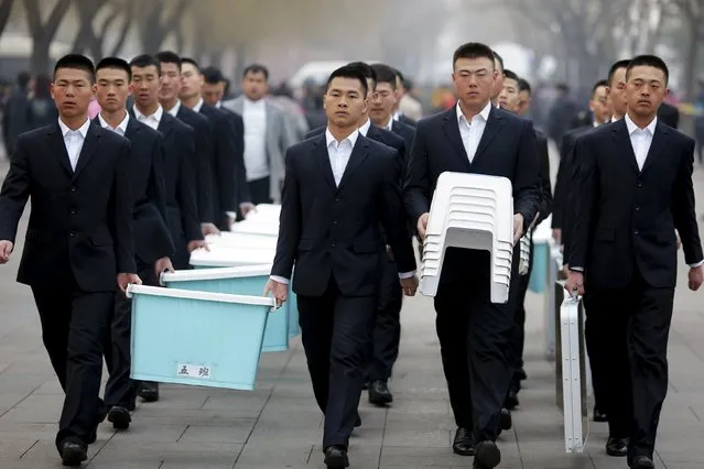 Security personnel carry items at Tiananmen square as the area near the Great Hall of the People is prepared for upcoming annual sessions of the National People's Congress (NPC) and Chinese People's Political Consultative Conference (CPPCC) in Beijing, China March 3, 2016. (Photo by Damir Sagolj/Reuters)